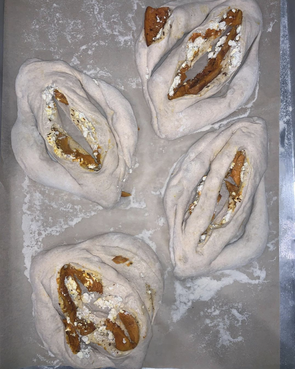 fougasse, cut and ready to bake filled with pumpkin and feta