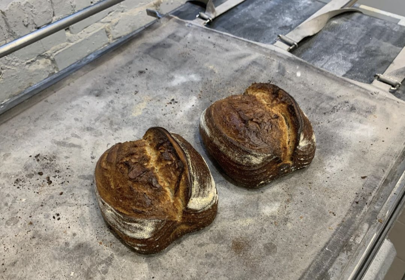 two golden loaves of bread, side by side